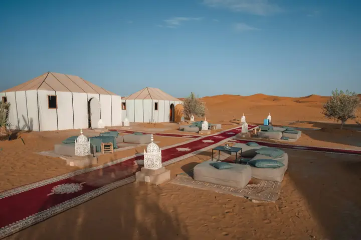 Camp of white tents among the Merzouga dunes