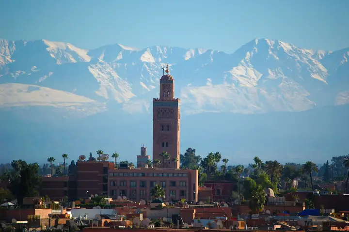 Koutoubia minaret in Marrakech with the snow-capped Atlas behind